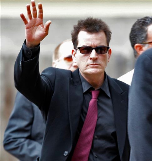 
 FILE - In a Aug. 2, 2010 file photo, Charlie Sheen waves as he arrives at the Pitkin County Courthouse in Aspen, Colo., for a hearing in his domestic abuse case. Appearing on ABC's 'Good Morning America' on Monday, Nov. 22, 2010, adult-film actress Capri Anderson, the woman found in Charlie Sheen's New York hotel room last month, says the actor hurled racial slurs, threw a lamp at her and grabbed her by the throat. She says she's suing Sheen for battery and false imprisonment, and plans to file a criminal report with New York police.(AP Photo/Ed Andrieski, File)
 
