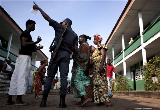 
 A policeman direcrts voters to the right polling station for the first round of presidential elections in Abidjan, Ivory Coast, Sunday Nov. 31, 2010. The West African nation of Ivory Coast held a long-awaited presidential election Sunday, the first since civil war erupted in 2002 and split the world's leading cocoa producer in half. Millions of people here are hoping the repeatedly delayed poll will reunite the divided country and restore stability after more than a decade of chaos and tension(AP Photo/Jerome Delay)
 