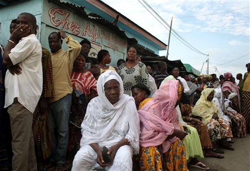 
 Voters wait in line outside a polling station to cast their ballot in the first round of presidential elections in Abidjan, Ivory Coast, Sunday Nov. 31, 2010. The West African nation of Ivory Coast held a long-awaited presidential election Sunday, the first since civil war erupted in 2002 and split the world's leading cocoa producer in half. Millions of people here are hoping the repeatedly delayed poll will reunite the divided country and restore stability after more than a decade of chaos and tension(AP Photo/Jerome Delay)
 