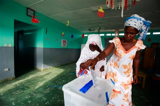 
 Awa Sylla, right, helps her grandmother Njama Sylla cast her vote for president at a polling station in a nursery school, in the former rebel stronghold of Bouake, in northern Ivory Coast, Sunday, Oct. 31, 2010. The West African nation of Ivory Coast held a long-awaited presidential election Sunday, the first since civil war erupted in 2002 and split the world's leading cocoa producer in half. (AP Photo/Rebecca Blackwell)
 