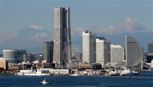 
 Against a backdrop of a snow-capped Mount Fuji, Japan's highest mountain, skyscrapers soar at Yokohama port, south of Tokyo, Wednesday, Nov. 3, 2010. The Asia-Pacific Economic Cooperation summit will be held in Yokohama on Nov. 13 and 14. (AP Photo/Itsuo Inouye)
 