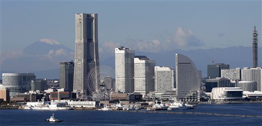 
 In this Nov. 3, 2010 photo, with a backdrop of snow-capped Mount Fuji, left, Japan's highest mountain, skyscrapers soar at Yokohama port, south of Tokyo. Japan, which hosts the annual Asia-Pacific Economic Cooperation forum next weekend in Yokohama, is embroiled in a flare-up of territorial disputes with China and Russia that is stirring up rancor in all three countries and is already prompting economic fallout. (AP Photo/Itsuo Inouye)
 