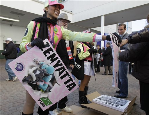 
 Ashley Miller hands out posters of Zenyatta to patrons as they enter the gates for the Breeder's Cup horse races at Churchill Downs Saturday, Nov. 6, 2010, in Louisville, Ky. (AP Photo/Darron Cummings)
 