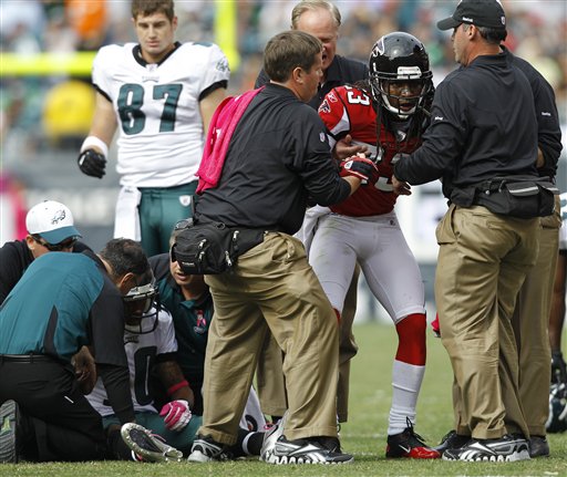 
 FILE - This Oct. 17, 2010, file photo shows Atlanta Falcons corner back Dunta Robinson, right, and Philadelphia Eagles wide receiver DeSean Jackson, left, helped after a hit during the first half of an NFL football game, in Philadelphia. The NFL's brain, neck and spine committee meets Wednesday, Dec. 8, 2010, to talk about possible changes to helmets and other equipment. (AP Photo/Mel Evans, File)
 