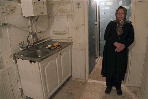 
 In this photo released by state-run Press TV, Sakineh Mohammadi Ashtiani, sentenced to death by stoning for adultery, stands in her home where her husband was killed, in the city of Osku, Iran, Dec. 6, 2010. The 43-year-old mother of two was brought from the prison to her home in northwestern Iran to 'produce a visual recount of the crime at the murder scene,' Press TV announced, denying reports that she had been released. (AP Photo/Press TV) EDS NOTE: THE ASSOCIATED PRESS HAS NO WAY OF INDEPENDENTLY VERIFYING THE CONTENT, LOCATION OR DATE OF THIS IMAGE.
 