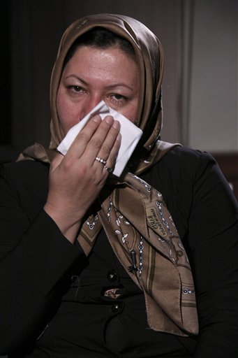 
 In this photo released by state-run Press TV, Sakineh Mohammadi Ashtiani, sentenced to death by stoning for adultery, wipes her face during an interview with Press TV, in Tabriz, Iran, Sunday, Dec. 5, 2010. The 43-year-old mother of two was brought from the prison to her home in northwestern Iran to 'produce a visual recount of the crime at the murder scene,' Press TV announced, denying reports that she had been released. (AP Photo/Press TV) EDS NOTE: THE ASSOCIATED PRESS HAS NO WAY OF INDEPENDENTLY VERIFYING THE CONTENT, LOCATION OR DATE OF THIS IMAGE.
 