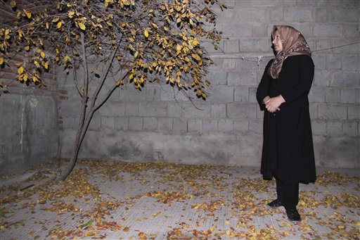 
 In this photo released by state-run Press TV, Sakineh Mohammadi Ashtiani, sentenced to death by stoning for adultery, stands in the courtyard of her home in the city of Osku, Iran, Sunday, Dec. 6, 2010. The 43-year-old mother of two was brought from the prison to her home in northwestern Iran to 'produce a visual recount of the crime at the murder scene,' Press TV announced, denying reports that she had been released. (AP Photo/Press TV) EDS NOTE: THE ASSOCIATED PRESS HAS NO WAY OF INDEPENDENTLY VERIFYING THE CONTENT, LOCATION OR DATE OF THIS IMAGE.
 