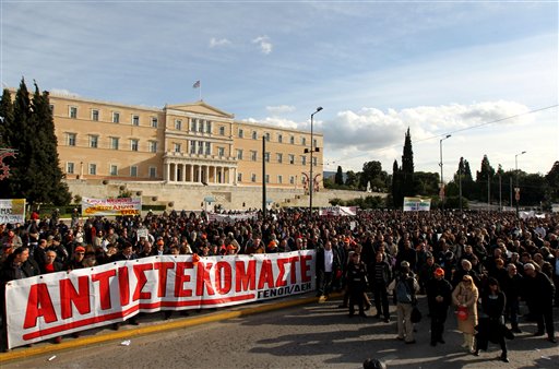
 Protesters hold a huge banner in front of the Greek Parliament which reads in Greek 'we resist' during a protest organized by Greece's two main labor unions against austerity measures in Athens, on Tuesday, Dec. 14, 2010. Public transport services were halted by strikes in greater Athens as unions stepped up protests against austerity measures in crisis-hit Greece. (AP Photo/Petros Giannakouris)
 