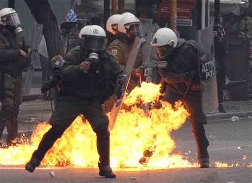 
 A petrol bomb explodes among riot police during clashes with protesters in Athens, Wednesday, Dec. 15, 2010. Some hundreds of protesters clashed with riot police across central Athens Wednesday, smashing cars and hurling gasoline bombs during a massive labor protest against the government's austerity measures during a general strike against a new round of labor reforms in the crisis-hit country. (AP Photo/Alkis Konstantinidis)
 