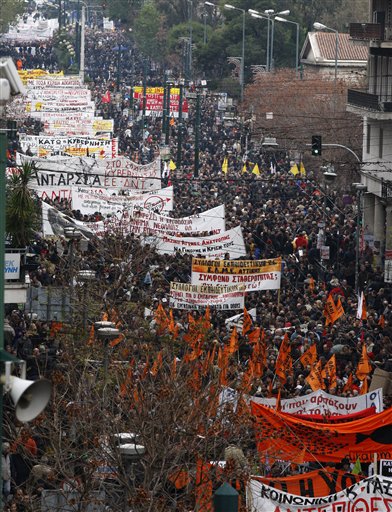 
 Protesters take part in a rally during a 24-hour strike in Athens, Wednesday, Dec. 15, 2010. Hundreds of protesters clashed with riot police across central Athens, smashing cars and hurling gasoline bombs during a massive labor protest against the government's austerity measures. The violence occurred after some 20,000 protesters marched to parliament during a general strike against a new round of labor reforms in the crisis-hit country. (AP Photo/Thanassis Stavrakis)
 