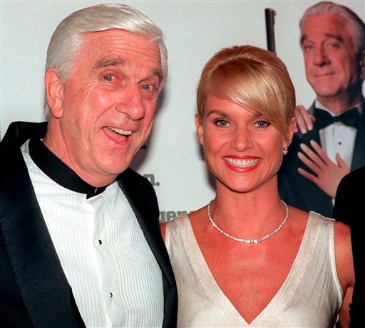 
 FILE - In this file photo taken May 16, 1996, actors Leslie Nielsen, left, and Nicollette Sheridan arrive at the El Capitan Theatre in Los Angeles for the premiere of 'Spy Hard.' The Canadian-born Nielsen, who went from drama to inspired bumbling as a hapless doctor in 'Airplane!' and the accident-prone detective Frank Drebin in 'The Naked Gun' comedies, has died. He was 84. His agent John S. Kelly said Nielsen died Sunday, Nov. 28, 2010, at a hospital near his home in Florida where he was being treated for pneumonia. (AP Photo/Michael Caulfield, File)
 