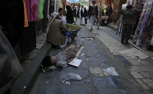 
 In this Saturday Nov. 13, 2010 photo a Yemeni boy looks back while laying on the ground as he begs for money in an alley of the old city of Sanaa, Yemen. More than 50 percent of Yemen's children are malnourished, rivaling war zones like Sudan's Darfur and parts of sub-Saharan Africa. That's just one of many worrying statistics in Yemen. Nearly half the population lives below the poverty line of $2 a day and doesn't have access to proper sanitation. Less than a tenth of the roads are paved. Water is running out. Tens of thousands have been displaced from their homes by conflict, flooding into cities. The government is riddled with corruption, has little control outside the capital, and its main source of income, oil, could run dry in a decade. (AP Photo/Muhammed Muheisen)
 