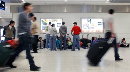 
 Passengers wait for their flights at Miami International Airport in Miami, Thursday, Dec. 23, 2010. (AP Photo/Alan Diaz)
 