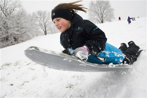 
 Sydney Baltyn, 9, slides off a snow jump as she sleds with her family at Stephens Lake Park in Columbia, Mo. on Friday Dec. 24, 2010. Christmas Eve snow blanketed the area allowing Greg and Michelle Baltyn to take their daughters Sydney, 9, and Molli, 6, sledding. (AP Photo/Columbia Daily Tribune, Gerik Parmele)
 
