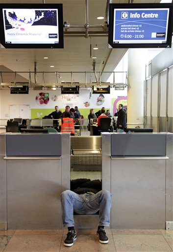 
 A man sleeps at a ticket check in at Zaventem airport in Brussels on Friday, Dec. 24, 2010. A new crop of snow caused air traffic chaos in Belgium on Friday, with its main airport either canceling or delaying many flights. (AP Photo/Virginia Mayo)
 