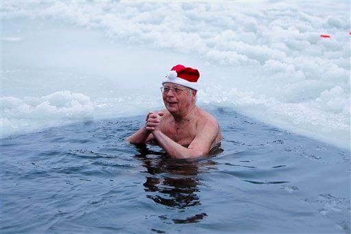 
 A member of the ice swimming club 'Seehunde Berlin' bathes in the frozen Oranke Lake in Berlin on Saturday, Dec. 25, 2010. Every Christmas the club arrange a Christmas swimming session in this lake. (AP Photo/Markus Schreiber)
 