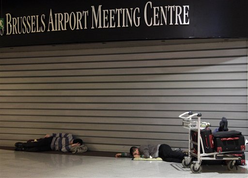 
 People sleep at Zaventem airport in Brussels on Friday, Dec. 24, 2010. A new crop of snow caused air traffic chaos in Belgium on Friday, with its main airport either canceling or delaying many flights. (AP Photo/Virginia Mayo)
 
