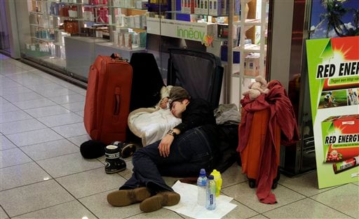 
 A man sleeps with his infant in a suitcase at Zaventem airport in Brussels on Friday, Dec. 24, 2010. A new batch of snow caused air traffic chaos in Belgium on Friday, with its main airport either canceling or delaying many flights. (AP Photo/Virginia Mayo)
 