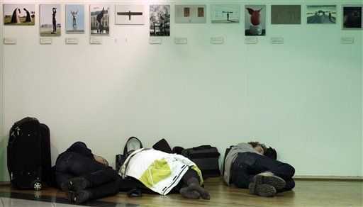 
 Three people sleep in a shop at Zaventem airport in Brussels on Friday, Dec. 24, 2010. A new batch of snow caused air traffic chaos in Belgium on Friday, with its main airport either canceling or delaying many flights. (AP Photo/Virginia Mayo)
 