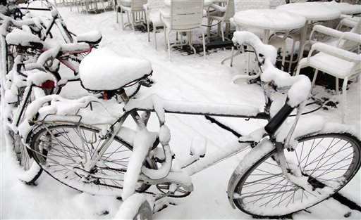 
 Snow covers bicycles and tables near the center of Antwerp, Belgium on Friday, Dec. 24, 2010. Belgium was blanketed with another batch of snow on Thursday evening adding to holiday travel chaos in the region. (AP Photo/Virginia Mayo)
 