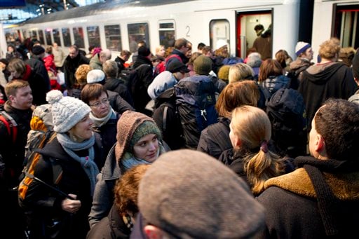 
 Passengers board a train departing from Berlin's central railway station to Schiphol, Netherlands, after the reopening of a track between Berlin and Hanover in Berlin, Germany, Friday, Dec. 24, 2010. The track is the most important East to West connection in Germany and was closed due to frosted overhead contact installations for the traction system in the morning. German news agency Dapd reports that five trains with a total of 700 passengers onboard got stuck due to the weather conditions. (AP Photo/Gero Breloer)
 
