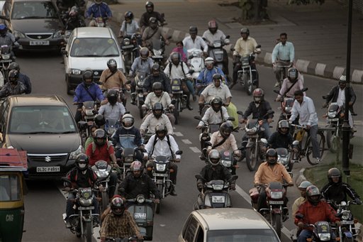 
 In this Monday, Nov. 1, 2010 photo, vehicles wait at a crossing as two-wheelers jam the traffic in New Delhi, India. Around 10 million cars, buses, trucks and an army of scooters and motorbikes pack into the cities potholed roads each day, causing unending traffic jams, frayed tempers and gridlock. A global road safety report by the World Health Organization says more people die in road accidents in India than anywhere else in the world, a phenomenon blamed on poor roads, speeding, and dangerous and reckless driving. (AP Photo/Manish Swarup)
 