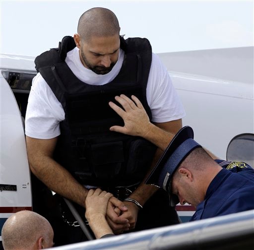 
 Elias Abuelazam is helped off a plane by authorities after arriving in Flint, Mich., Thursday, Aug. 26, 2010. Abuelazam had been held in an Atlanta jail since his Aug. 11 arrest at the city's airport. He waived extradition Aug. 13, and officials had 15 days to bring him to Michigan. The 33-year-old is charged with assault with intent to commit murder in the July 27 stabbing of a 26-year-old Flint man. It's one of 14 stabbings, of men in the Flint area, about 70 miles northwest of Detroit. He's also suspected in similar stabbings in Virginia and Ohio.(AP Photo/Paul Sancya, Pool)
 