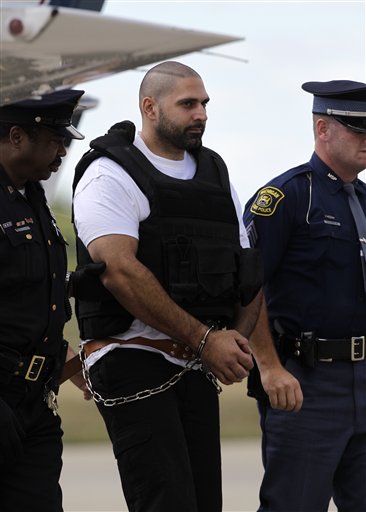 
 Elias Abuelazam is escorted by authorites after arriving in Flint, Mich., Thursday, Aug. 26, 2010. Abuelazam had been held in an Atlanta jail since his Aug. 11 arrest at the city's airport. He waived extradition Aug. 13, and officials had 15 days to bring him to Michigan. The 33-year-old is charged with assault with intent to commit murder in the July 27 stabbing of a 26-year-old Flint man. It's one of 14 stabbings, of men in the Flint area, about 70 miles northwest of Detroit. He's also suspected in similar stabbings in Virginia and Ohio. (AP Photo/Paul Sancya, Pool)
 