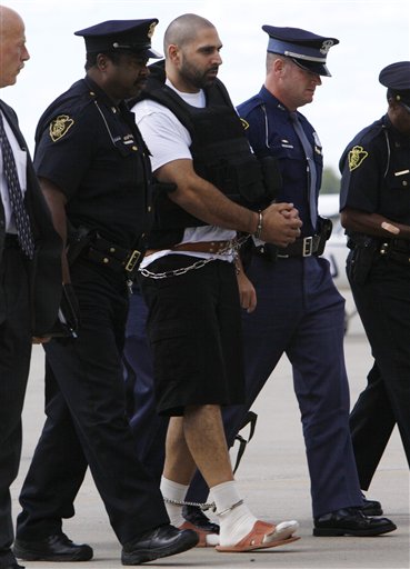 
 Elias Abuelazam is escorted by authorities after arriving on a flight in Flint, Mich., Thursday, Aug. 26, 2010. Abuelazam had been held in an Atlanta jail since his Aug. 11 arrest at the city's airport. He waived extradition Aug. 13, and officials had 15 days to bring him to Michigan. The 33-year-old is charged with assault with intent to commit murder in the July 27 stabbing of a 26-year-old Flint man. It's one of 14 stabbings, of men in the Flint area, about 70 miles northwest of Detroit. He's also suspected in similar stabbings in Virginia and Ohio. (AP Photo/Paul Sancya, Pool)
 