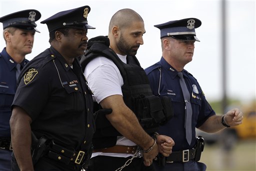 
 Elias Abuelazam is escorted by authorities after arriving on a flight in Flint, Mich., Thursday, Aug. 26, 2010. Abuelazam had been held in an Atlanta jail since his Aug. 11 arrest at the city's airport. He waived extradition Aug. 13, and officials had 15 days to bring him to Michigan. The 33-year-old is charged with assault with intent to commit murder in the July 27 stabbing of a 26-year-old Flint man. It's one of 14 stabbings, of men in the Flint area, about 70 miles northwest of Detroit. He's also suspected in similar stabbings in Virginia and Ohio.(AP Photo/Paul Sancya, Pool)
 