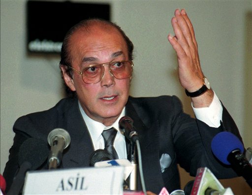 
 In this Friday, May 30, 1997 file picture Asil Nadir the former chairman of food and electronics conglomerate 'Polly Peck' gestures during the press conference in Istanbul,Turkey. A tycoon who fled Britain almost two decades ago following the spectacular collapse of his business empire told British media Thursday that he is returning to London to face charges of fraud.Asil Nadir said he was on his way to Britain to write the final chapter of a boom-and-bust story that tarnished the reputation of the Conservative Party _ to which he was a major donor _ and made him a fugitive from British justice for 17 years.(AP Photo/Murad Sezer/File)
 