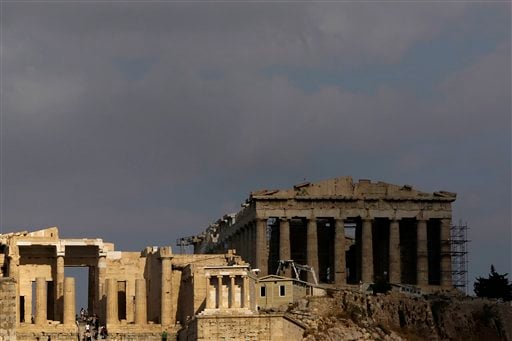 
 In this photo taken Sunday, Sept. 5, 2010, the elegant marble temple of Athena Nike, distinguished by its four Ionic columns, is lit by the sun as the Propylaea gate is seen on the left and the Parthenon temple in the shade on the right, on the Athens Acropolis. A ten-year restoration project has just been completed on the 2,400-year-old temple, which was dismantled to ground level and rebuilt to correct damage from ground subsidence and rusting internal joints. (AP Photo/Petros Giannakouris)
 