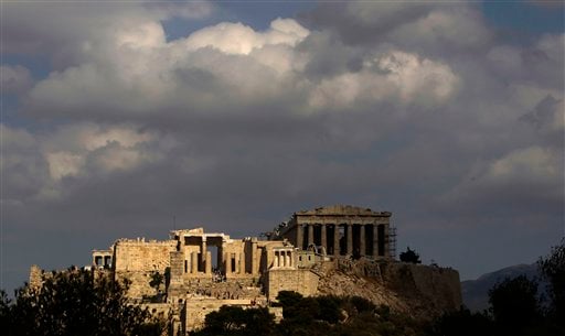 
 In this photo taken Sunday, Sept. 5, 2010, the elegant marble temple of Athena Nike, distinguished by its four Ionic columns, is lit by the sun as the Propylaea gate is seen on the left and the Parthenon temple in the shade on the right, on the Athens Acropolis. A ten-year restoration project has just been completed on the 2,400-year-old temple, which was dismantled to ground level and rebuilt to correct damage from ground subsidence and rusting internal joints. (AP Photo/Petros Giannakouris)
 