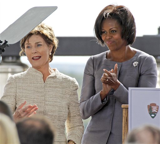 
 Former first lady Laura Bush, left, is applauded by first lady Michelle Obama, after making her remarks during a commemorative service at the temporary Flight 93 memorial in Shanksville, Pa., Saturday, Sept. 11, 2010. (AP Photo/Gene J. Puskar)
 