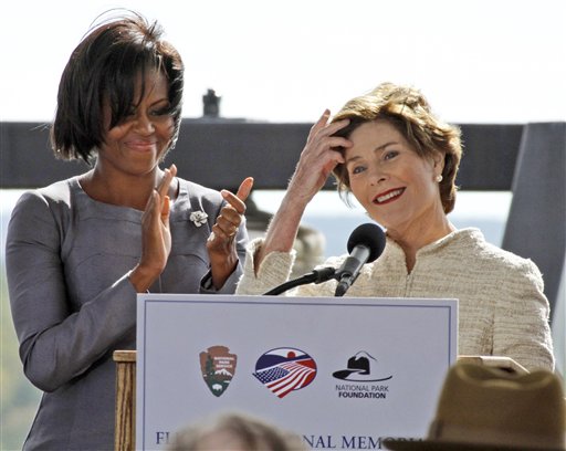 
 Former first lady Laura Bush, right, finishes her remarks as first lady Michelle Obama applauds during a commemorative service at the temporary Flight 93 memorial in Shanksville, Pa., Saturday, Sept. 11, 2010. (AP Photo/Gene J. Puskar)
 