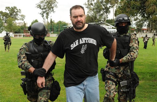 
 Marines escort alleged drug kingpin Sergio Villarreal Barragan, aka 'El Grande,' center, during his presentation to the press in Mexico City, Monday, Sept. 13, 2010. Villarreal, an alleged leader of the Beltran Leyva drug cartel, was captured in a raid Sunday, according to a statement released by the Mexican Navy. (AP Photo/Miguel Tovar)
 