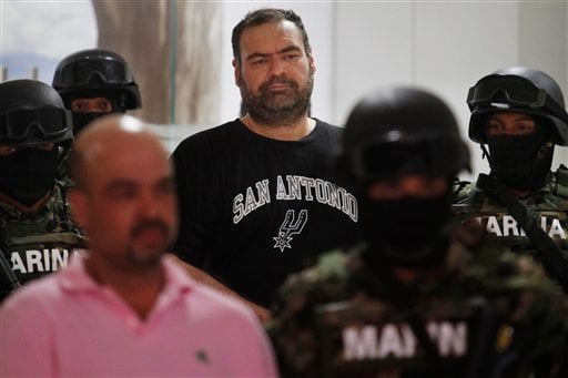 
 Marines escort alleged drug kingpin Sergio Villarreal Barragan, aka 'El Grande,' center, during his presentation to the press in Mexico City, Monday, Sept. 13, 2010. Villarreal, an alleged leader of the Beltran Leyva drug cartel, was captured in a raid Sunday, according to a statement released by the Mexican Navy. (AP Photo/Miguel Tovar)
 