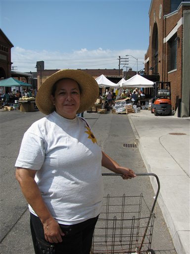 
 This Saturday, Aug. 7, 2010 picture shows Elizabeth Luna, 58, at the Eastern Market in Detroit. Luna had been shopping at Eastern Market in Detroit regularly for 39 years. But when she lost her job in accounting last year, she stopped. She returned after she began receiving food stamps and learned how to use them there. SNAP benefits are administered through an electronic debit system that works much like a debit card. At some markets like Detroit's, shoppers use their SNAP card to buy tokens that can be spent at farmers' stands. (AP Photo/David Runk)
 