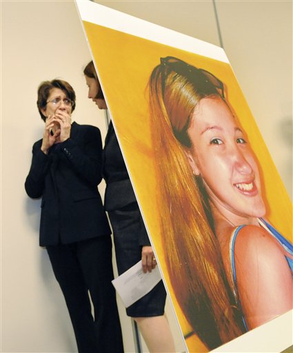 
 Carmen Guzman, mother of Julissa Brisman, reacts as she walks with attorney Djuna Perkins after a family friend read a victim impact statement in Boston, Thursday, September 16, 2010. Philip Markoff, the former Boston University medical student, was accused of killing Julissa Brisman last year. Due to the death of Philip Markoff, authorities have dropped the charges against Markoff. An undated photograph of Julissa Brisman is seen at right. (AP Photo/Lisa Poole)
 