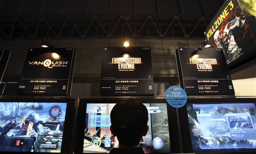 
 A visitor tries out Sony's new game 'Front Mission Evolved' at the company's booth during the Tokyo Game Show in Makuhari, near Tokyo, Thursday, Sept. 16, 2010. Sony's PlayStation 3 game console will work as a Blu-ray disc player for 3-D movies and music videos, not just 3-D games, with a software update download starting Sept. 21.(AP Photo/Junji Kurokawa)
 