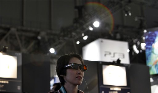 
 A visitor tries on 3D glasses as she watches a demonstration of 3D games at Sony's booth during the Tokyo Game Show in Makuhari, near Tokyo, Thursday, Sept. 16, 2010. Sony's PlayStation 3 game console will work as a Blu-ray disc player for 3-D movies and music videos, not just 3-D games, with a software update download starting Sept. 21.(AP Photo/Junji Kurokawa)
 