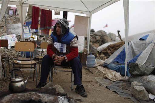 
 Cristian Segovia, son of trapped miner Dario Segovia, sits at the camp where relatives wait outside the collapsed San Jose mine in Copiapo, Chile, Tuesday Aug. 31, 2010. Thirty-three men stuck far underground are now the longest-trapped miners in recent history as a huge drill begins digging a planned escape route. The miners have been trapped since Aug. 5. (AP Photo/Roberto Candia)4
 