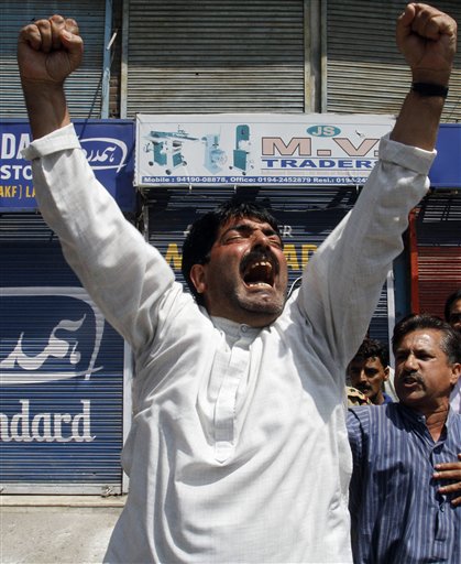 
 A Kashmiri Muslim shouts anti Indian slogans after police fire at a group of people playing carom board on a street during a curfew in Srinagar, India, Monday, Aug. 30, 2010. (AP Photo/Mukhtar Khan)
 