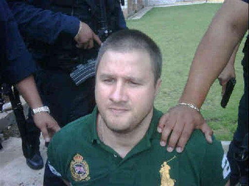 
 In this image released by Mexico's Public Safety Department on Monday Aug. 30, 2010, Edgar Valdez Villarreal, alias 'the Barbie,'' is escorted by police officers in the state of Mexico, which borders the capital, Mexico City. Federal police on Monday, Aug. 30, 2010, captured Valdez Villarreal, a Texas-born alleged drug kingpin, who faces trafficking charges in the U.S. and has been blamed for a vicious turf war that has included bodies hung from bridges and shootouts in central Mexico.(AP Photo/Mexico's Public Safety Department)
 