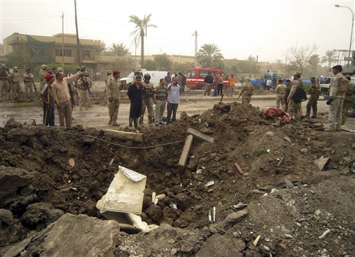 
 Iraqis inspect a crater caused by a suicide car bomb targeting a crowded commercial area near an AsiaCell store, one of Iraq's biggest mobile phone providers in Baghdad, Iraq, Sunday, Sept. 19, 2010. Two car bombs exploded during the morning rush hour killing and wounding scores of people, police said. (AP Photo)
 