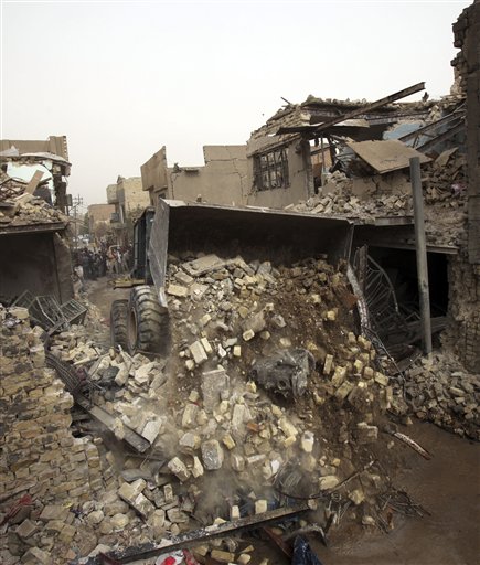 
 A bulldozer removes debris after a car bomb attack in Baghdad's Kazimiyah neighborhood, Iraq, Sunday, Sept. 19, 2010. Sunday's deadliest attack took place in north Baghdad's Kazimiyah neighborhood when a car bomb detonated near Adan square, killing at least 21 people and wounding more than 70, police and hospital officials said. (AP Photo/Karim Kadim)
 