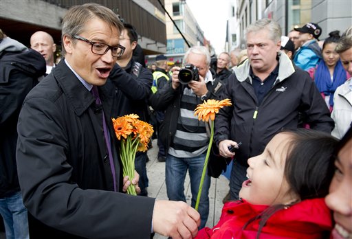 
 Sweden's Christian Democrat party leader Goran Hagglund, left, presents flowers on election day in Stockholm, Sweden Sunday Sept. 19, 2010. Voting started Sunday in Sweden's election with polls showing the center-right government heading for a historic second term, but an Islam-bashing far-right group could spoil its majority. (AP Photo/Pontus Lundahl)
 