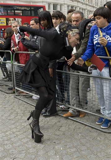 
 Daphne Guinness trips on the cobbled streets as she arrives to attend the Alexander McQueen memorial service at St Paul's Cathedral in London Monday, Sept. 20, 2010, which takes place during London Fashion Week. (AP Photo/Joel Ryan)
 