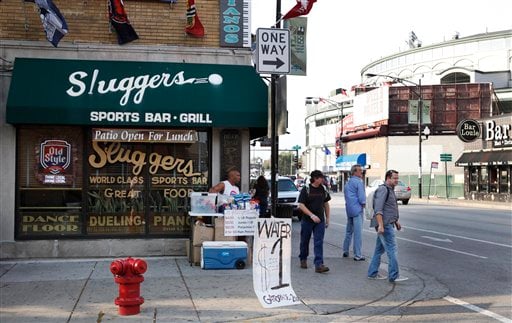 
 Patron of Sluggers Sports Bar and Grill walk along Clark Street on block from Wrigley Field, background, before a baseball game between the San Francisco Giants and Chicago Cubs Tuesday, Sept. 21, 2010 in Chicago. Sami Samir Hassoun, 22, a Lebanese citizen living in Chicago for about three years, was charged Monday with one count each of attempted use of a weapon of mass destruction and attempted use of an explosive device outside the bar last Saturday night. Hassoun, allegedly placed a backpack he thought contained a bomb outside the bar but got a fake explosive from an FBI undercover agent, authorities say. (AP Photo/Charles Rex Arbogast)
 