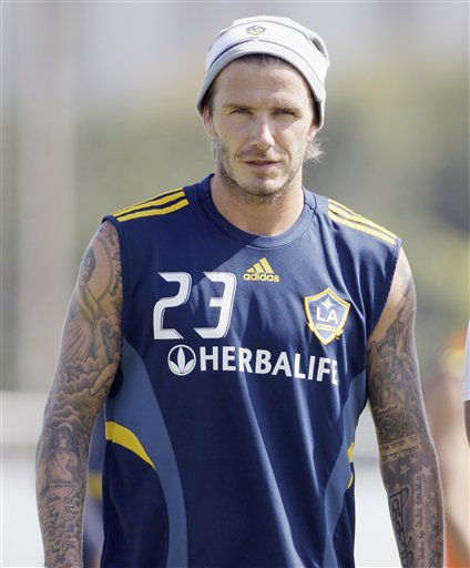 
 Los Angeles Galaxy's David Beckham looks on during a soccer training session in Carson, Calif., Thursday, Sept. 23, 2010. Beckham's management company says it is taking legal action against a U.S. magazine that published claims the former England captain slept with prostitutes. The company says in a statement the allegations in the weekly In Touch are 'completely untrue and totally ridiculous as the magazine was clearly told before publication.' (AP Photo/Reed Saxon)
 
